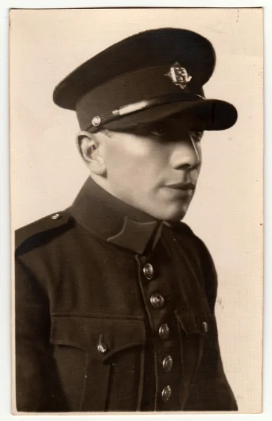 A vintage studio photo shows soldier. Antiqoue black & white portrait. — Stock Photo, Image