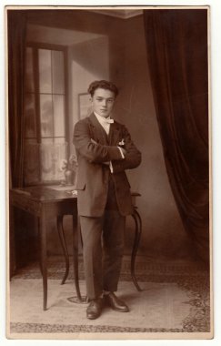 Vintage fotoğraf genç adam pozlar odaya gösterir. Antik siyah ve beyaz stüdyo portre.