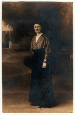 Vintage Fotoğraf kadın pozlar bir fotoğraf stüdyosunda gösterir. Fotoğraf karanlık sepya tonu ile. Siyah ve beyaz stüdyo portre.