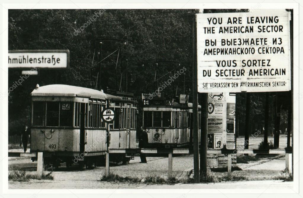 Vintage photo shows checkpoint between west (American sector) and ost Berlin. Tram leaves American sector.