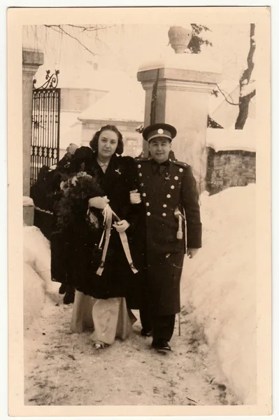 Vintage photo shows newlyweds after wedding ceremony in the church. Wedding ceremony happens in winter. — Stock Photo, Image