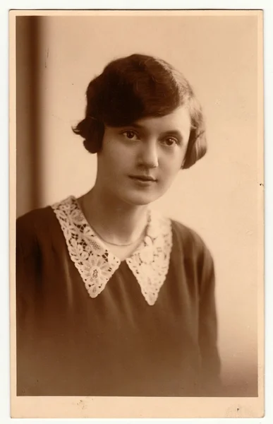 The vintage photo shows portrait of young woman. The studio photography with sepia effect was taken in early 1930s. — Stock Photo, Image