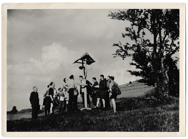 Foto retro muestra turistas van a dar un paseo. Están frente a la señal turística. Fotografía vintage en blanco y negro . — Foto de Stock