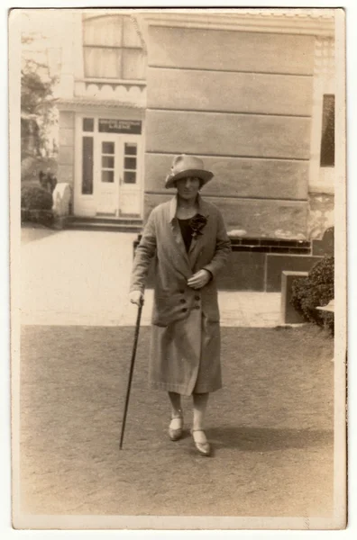 Vintage φωτογραφία δείχνει γυναίκα με ένα ραβδί στο θέρετρο σπα. Η γυναίκα πάει μια βόλτα. Ρετρό μαύρη & λευκή φωτογραφία. — Φωτογραφία Αρχείου