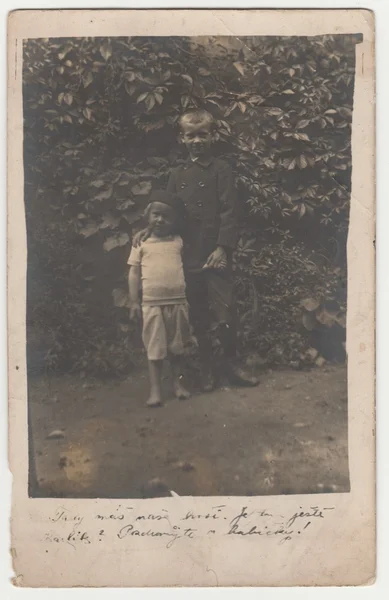 Vintage photo shows two boys (siblings) outdoors. Retro black & white photography. Photo was taken in Austro-Hungarian Empire or also Austro-Hungarian Monarchy. — Stock Photo, Image