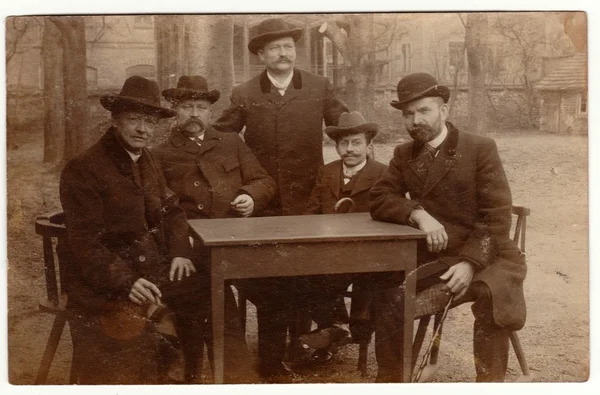 Vintage fotó mutatja a férfiak viselnek bowlers, és üljön az asztalra. Retro fekete reggeli fehér fotózás. — Stock Fotó