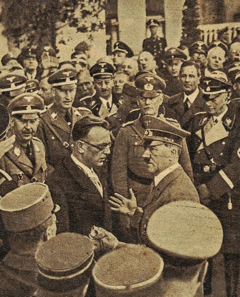 Arthur Seyss-Inquart with Adolf Hitler . Seyss-Inquart drafted the legislative act reducing Austria to a province of Germany and signed it into law on 13 March. With Hitlers approval he became