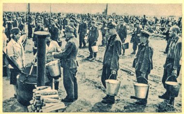 EAST EUROPE - 1944: German soldiers in POW camp. In the photo German soldiers are queuing for food, portion of soup. clipart