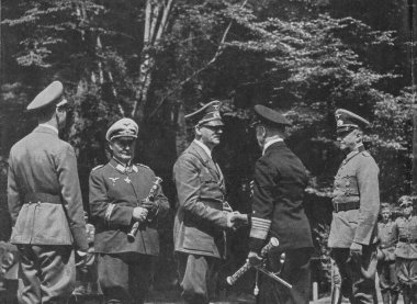COMPIEGNE, FRANCE - JUN 21, 1940: The meeting of fascist leaders before armistice with Francein Compiegne. From left to right: Deputy Fuhrer Rudlof Hess, Reichsmarschall Hermann Goring, Adolf Hitler, Admiral Erich Raeder and Field Marshal Walter von  clipart