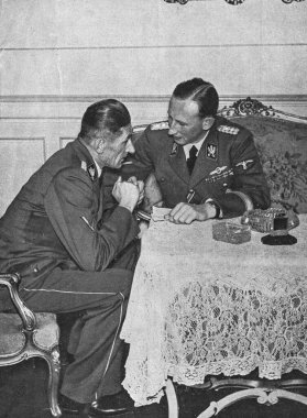 PRAGUE, PROTECTORATE OF BOHEMIA AND MORAVIA - CIRCA 1941: Reinhard Heydrich (right) and K.H. Frank at Prague castle. clipart