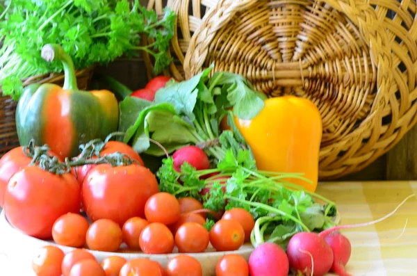 Tomates, rabanetes, pimentos, salsa e wickerwork handbasket — Fotografia de Stock