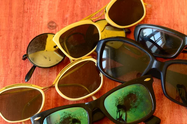 Kahverengi ahşap zemin üzerinde vintage güneş gözlüğü seti — Stok fotoğraf