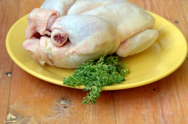 Raw chicken with a bunch of basil. — Stock Photo, Image