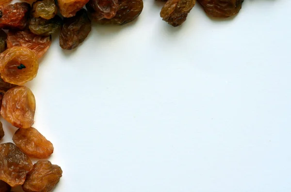 Isolated heap of golden raisins on white background — Stock Photo, Image