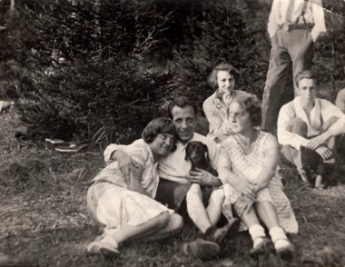 A young boy with girls. Vintage photo.  Early forties