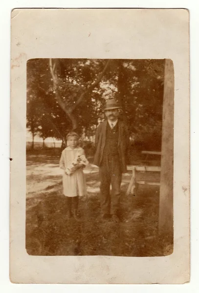 A small girl with her grandfather. Vintage photo was taken in Hodonin (the Czech Republic). Early forties — Stock Photo, Image