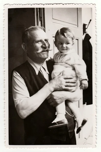 A small girl with her grandfather. Vintage photo was taken in Hodonin (the Czech Republic). Early forties. — 스톡 사진