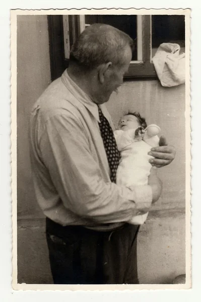 Grandfather with baby girl. Vintage photo was taken in 24. 7. 1940. — 스톡 사진