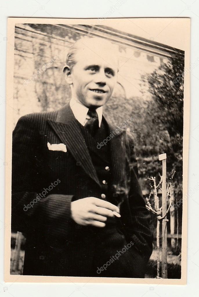 Vintage photo of man with cigarette. Portrait photo was taken in June 1938.