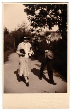 Vintage photo shows mother and her son who go for a walk, circa 1930s.