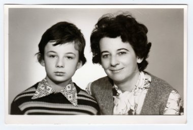 Retro photo of mother and her son. Portrait photo was taken in photo studio, circa 1980s.