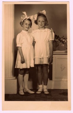 AA vintage photo of the young girls - the first holy communion. Photo with colour tint, circa 1945.