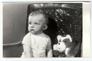 Retro photo of a small boy with teddy bear.  Portrait photo was taken in photo studio, circa 1972.