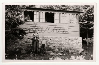 Vintage photo shows the small children with their grandfather, circa 1941.