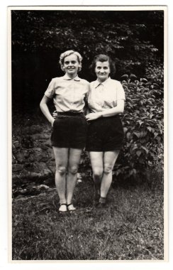 A vintage photo shows women on vacation, circa 1950s.