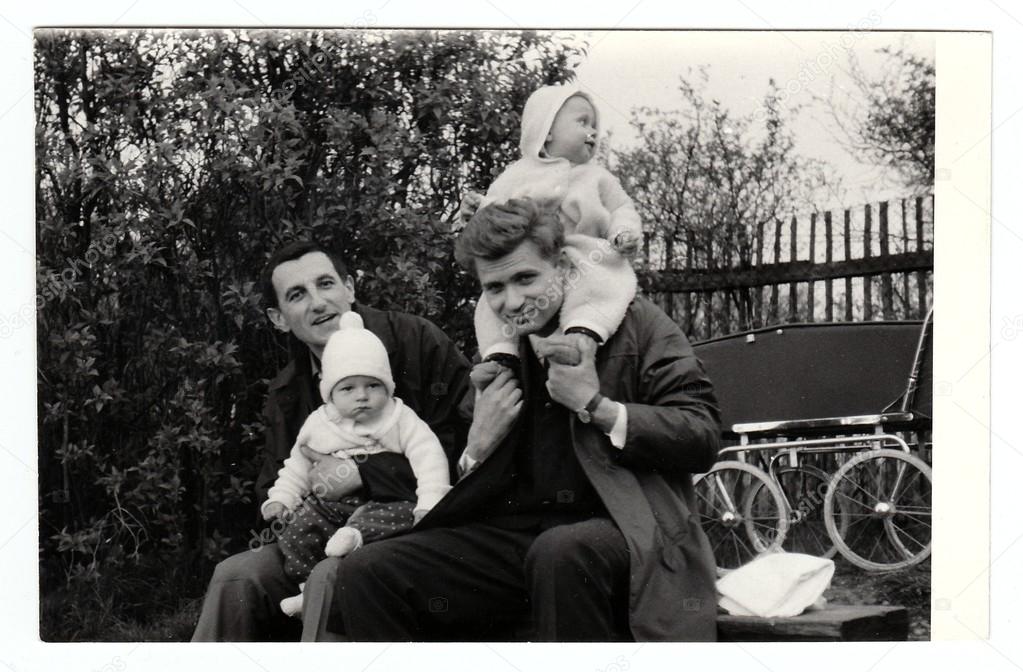 Retro photo shows fathers with their baby children