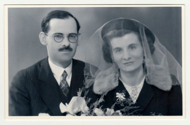 A vintage photo shows wedding  portrait of newly-weds, circa 1935.