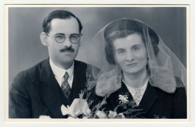 A vintage photo shows wedding  portrait of newly-weds, circa 1935.