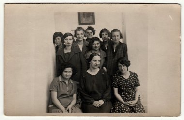 Vintage photo shows a group of girls (classmates) in school hallway with tutor, 1927 in Hodonin.