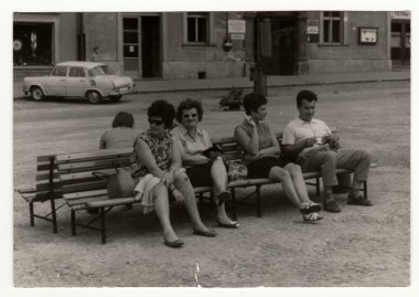 Vintage photo shows people sit on a bench, circa 1950s. clipart