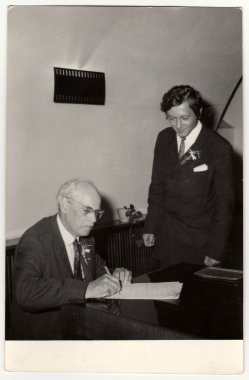 A vintage photo shows grandfather to signature wedding documents, circa 1970.
