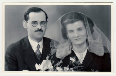 A vintage photo shows wedding  portrait of newly-weds, circa 1935.