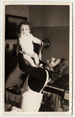 Vintage photo shows a small girl with her mother, circa 1941.
