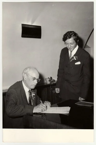 A vintage photo shows grandfather to signature wedding documents, circa 1970. — ストック写真