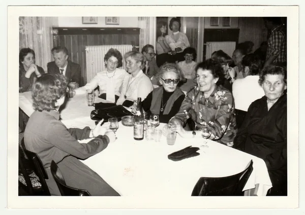 Vintage photo shows a group of people in the restaurant. — Stock fotografie