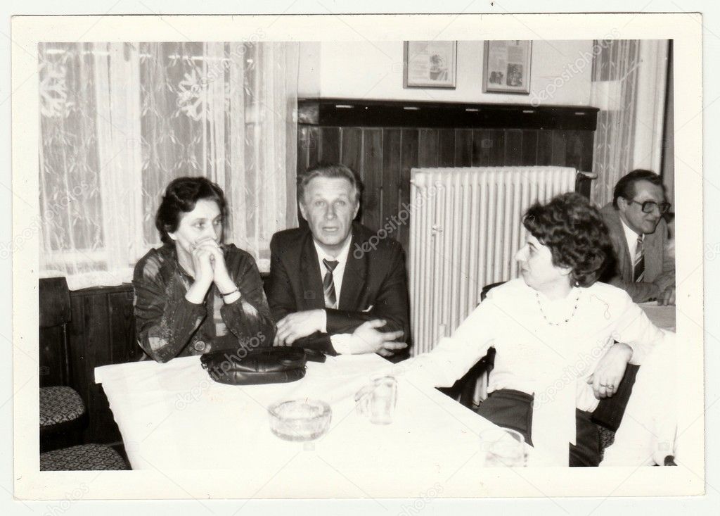 Vintage photo shows a group of people in the restaurant.