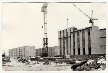 Vintage photo shows construction of blocks of flats in USSR. Winter time. clipart