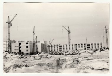 Vintage photo shows construction of blocks of flats in USSR. Winter time. clipart