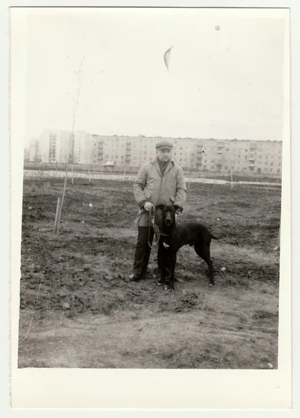 Vintage photo shows man walks the dog. — Stock Photo, Image