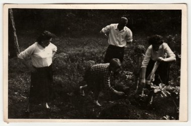 A vintage photo shows family outdoors. clipart