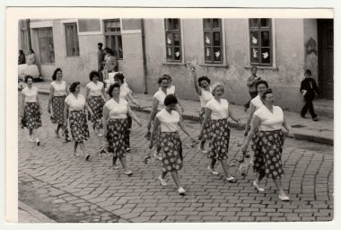 Vintage photo shows women prepare to Spartakiada.  Spartakiada - a prezentation of health and prosperity of the socialist and communist regime. clipart