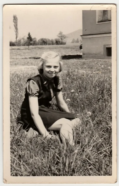 Vintage photo montre fille assise sur l'herbe . — Photo