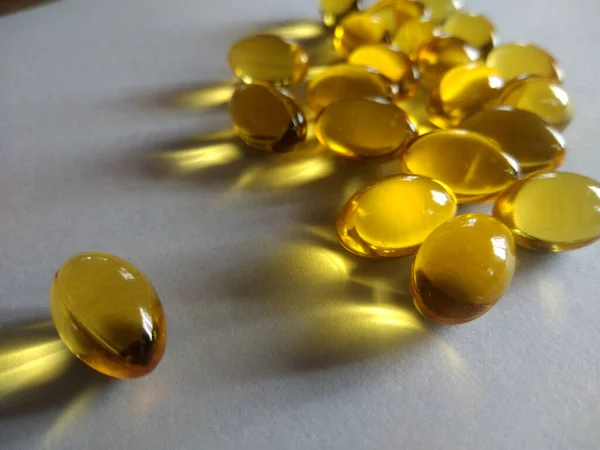 Bitki yağı, soğuk baskılı vitamin kapsülü, vücut bakımı ilacı. Sarı parlak yağ sağlık takviyesi