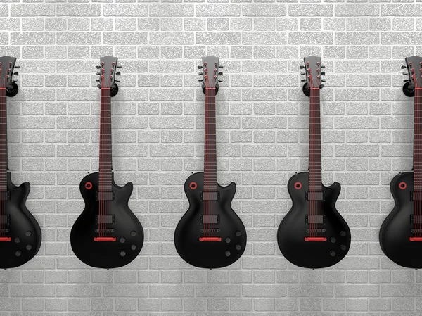 砖的墙上挂着的几个吉他 — 图库照片