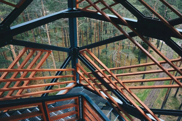 Close up view on observation tower construction elements, wooden tower in forest, wooden stairs