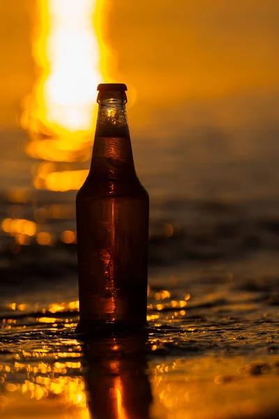 Una Bottiglia Birra Leggera Sulla Spiaggia Tramonto Riva Del Mare — Foto Stock